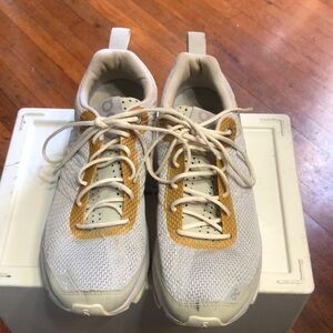 On Running White and Gold Sneakers